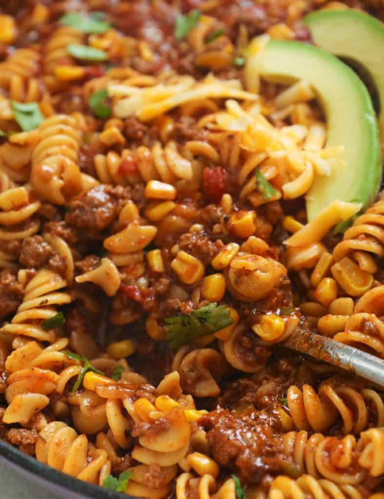 Taco Pasta Topped with Cheese and Avocado Slices