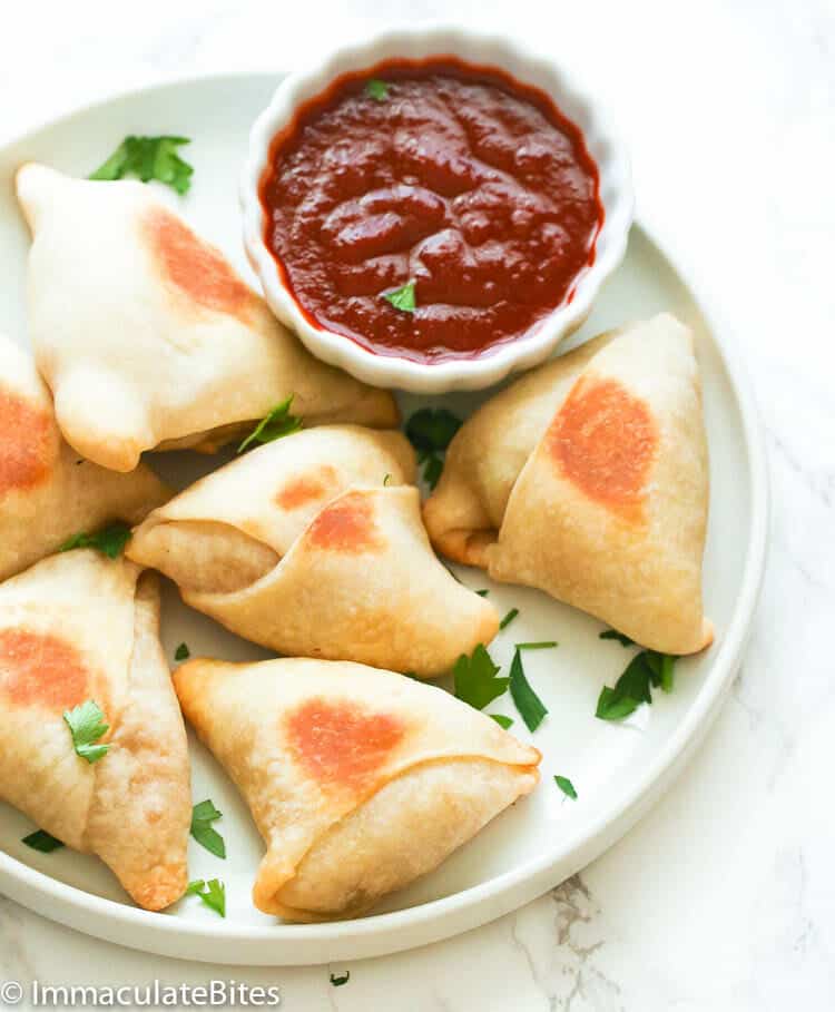 Appetizing samosas with spicy hot sauce