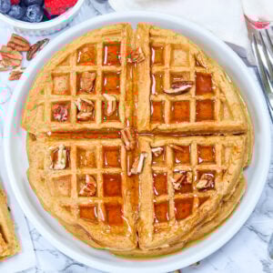 Serving up fresh, homemade sweet potato waffles with fresh berries and maple syrup